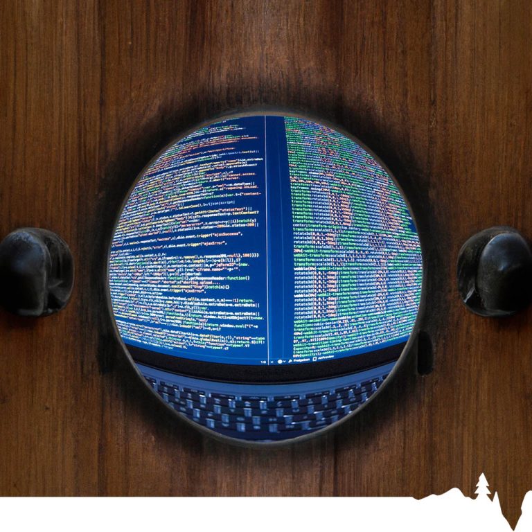 Close-up view of computer code displayed on a screen with colorful text and symbols.