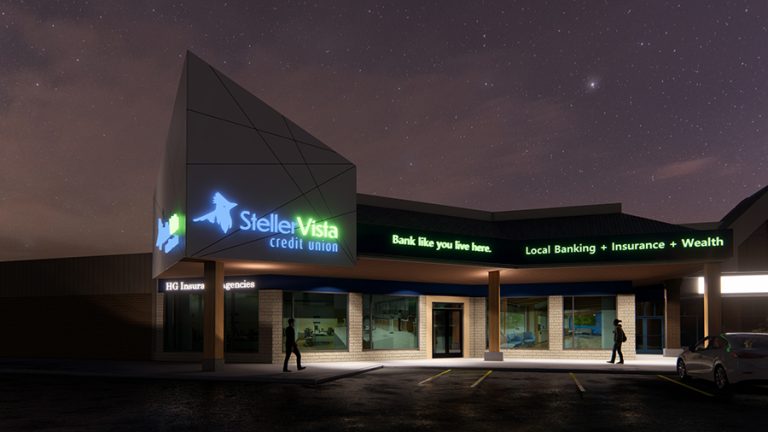 Exterior view of Steller Vista Credit Union building at night with illuminated signage.