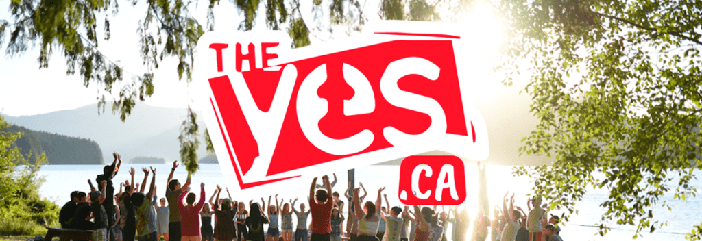 A group of people raising their hands outdoors with a large YES logo overlay.